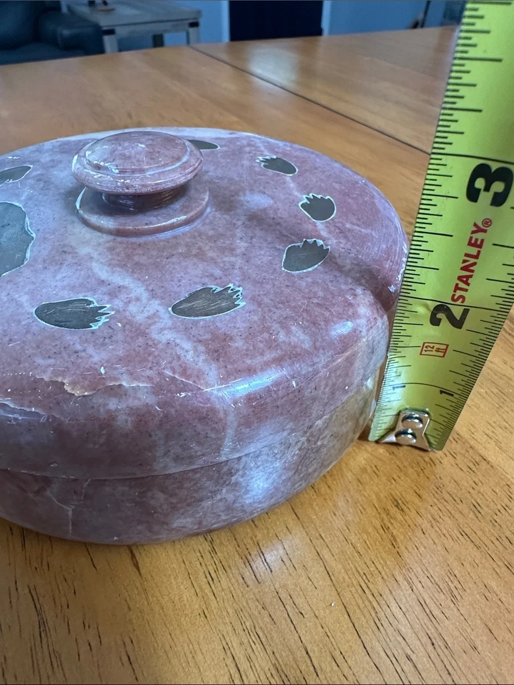 Soapstone trinket box with brass bear and paw prints inlaid. Hand carved.